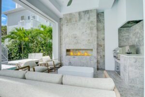 The Sand Castle - outdoor fireplace and kitchen - screened porch
