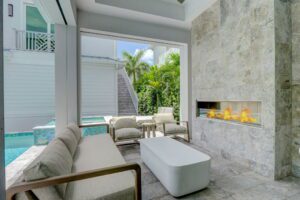 The Sand Castle - outdoor fireplace and kitchen - screened porch